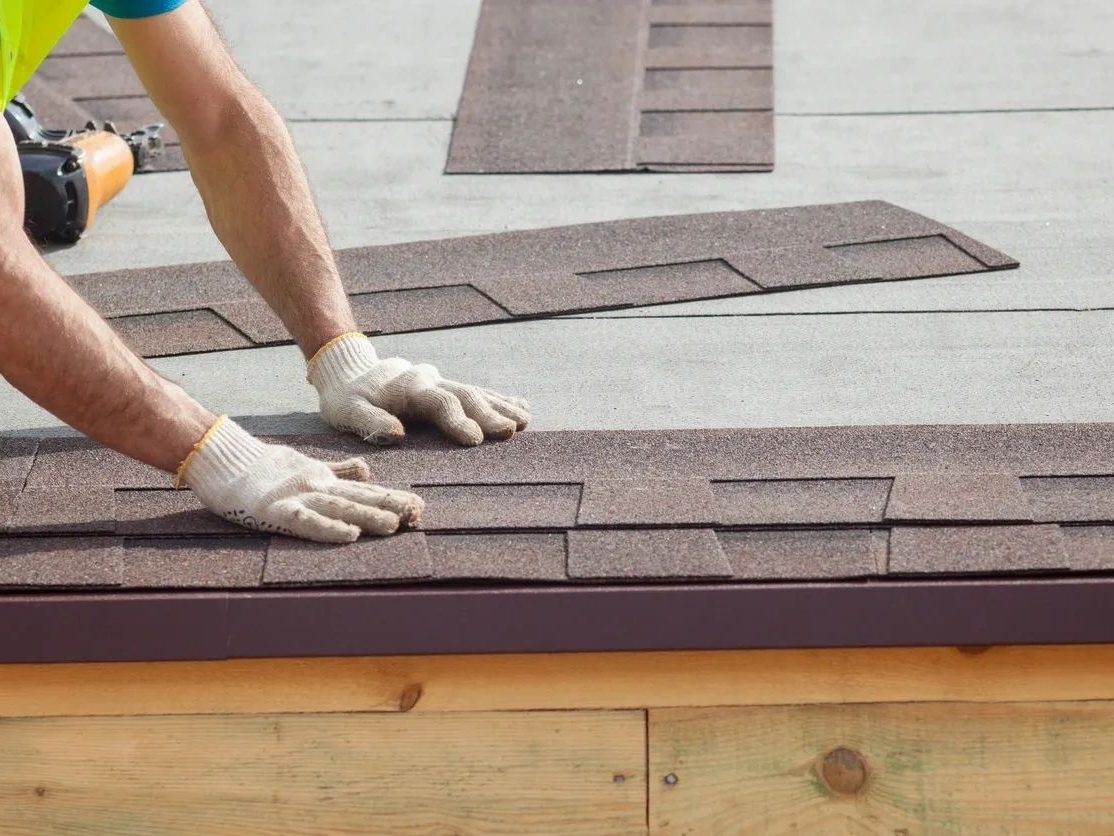 Advantage Roofing crew hand-laying architectural shingles